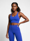 Women’s blue sports bra front view with supportive activewear fit
